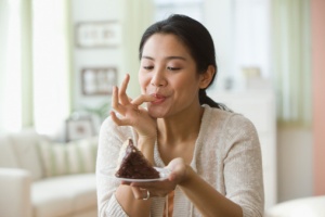 Asian woman eats cake